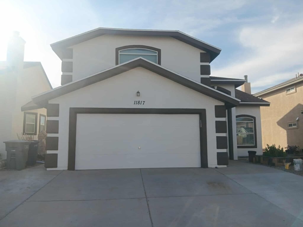 Freshly coated two-story home exterior with garage in El Paso, Texas